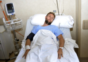 hospital injuries-man lying in hospital bed